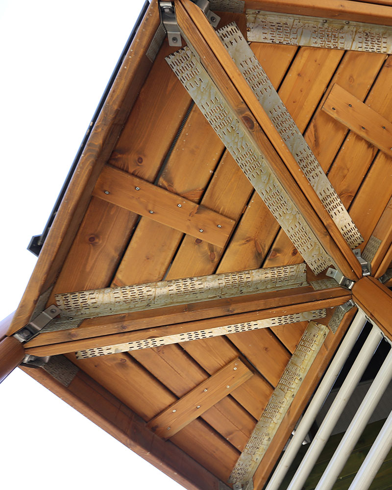 Image looking up at wooden detailing of UniPlay playground systems made out of wood.